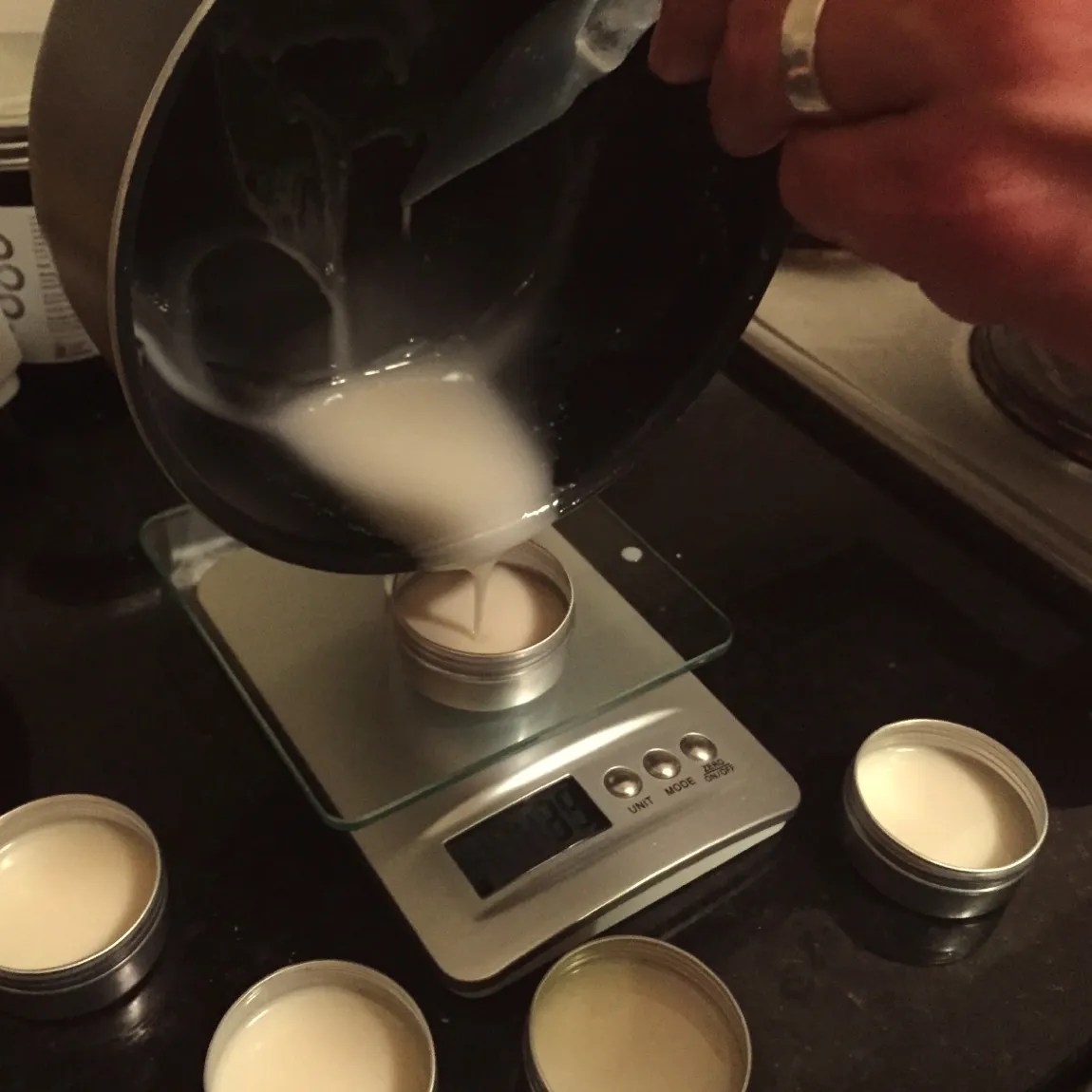 Pouring an early batch of No Pong from a saucepan into tins on the kitchen scales, 2015